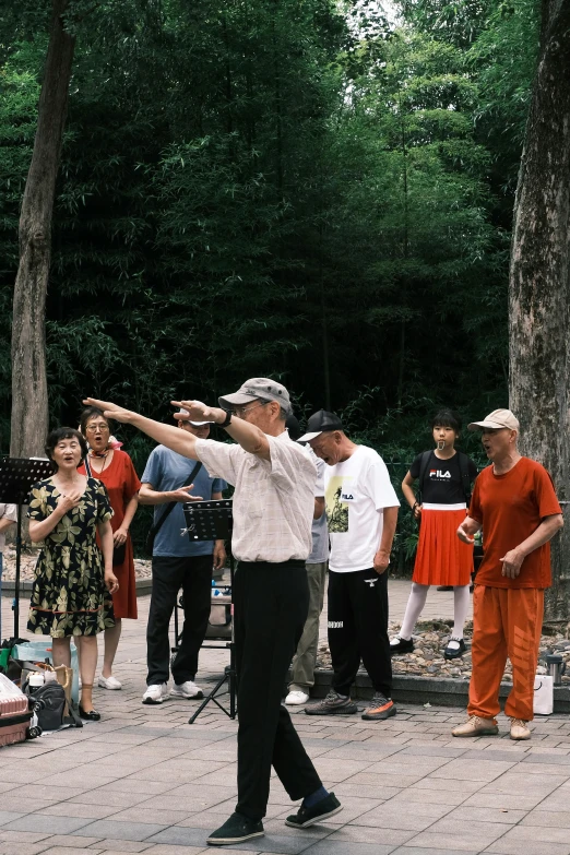 the elderly man is practicing taido at the park