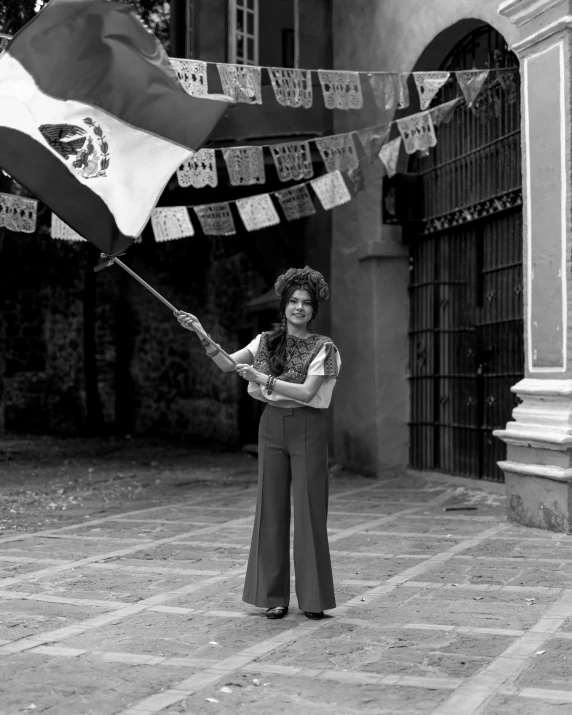 a woman with long hair, holding an umbrella and flag