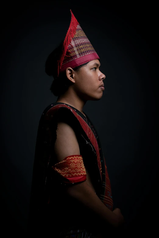 young man in red, black and gold dress