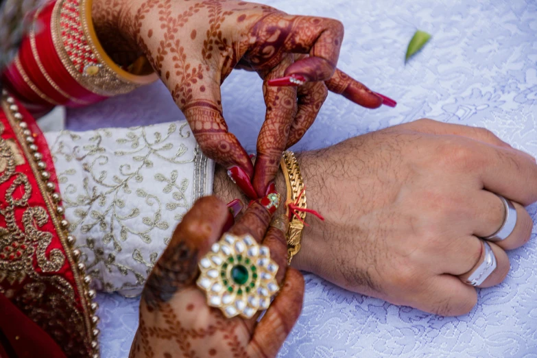 indian bride showing off her engagement ring to groom