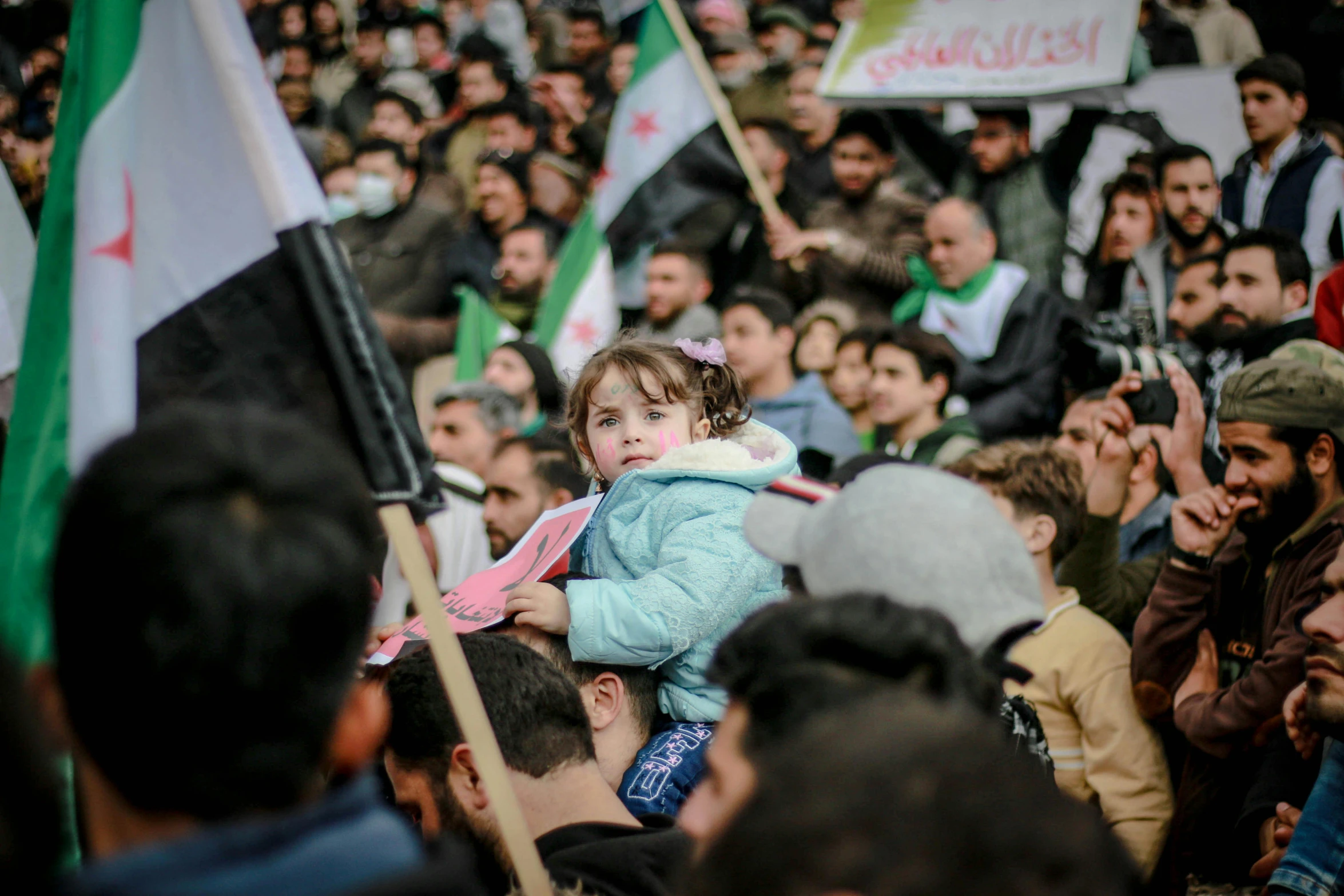 a girl carrying a doll is surrounded by people