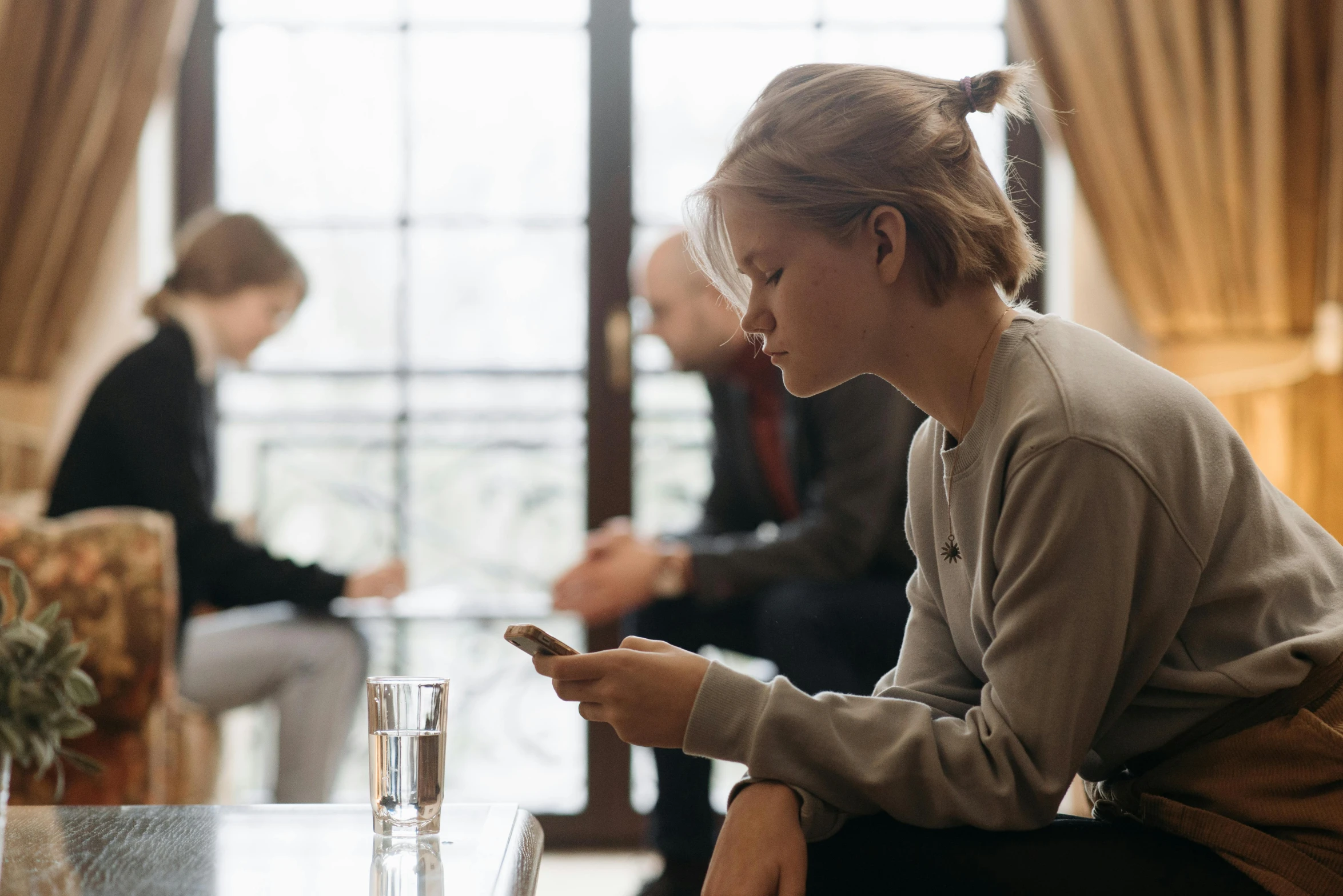 there is a young woman texting on her phone