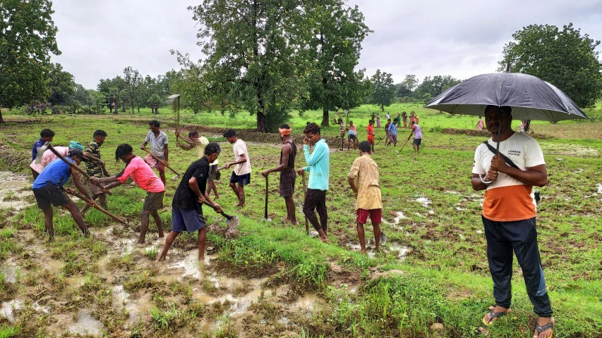 a person standing in the mud with an umbrella