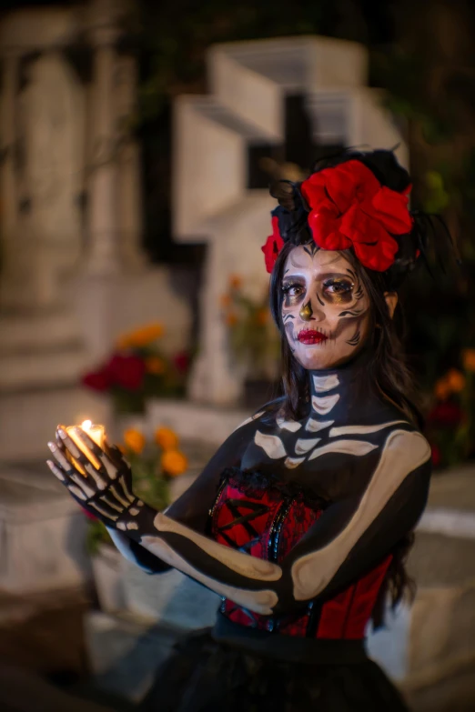 a woman with skeleton makeup and fake hands
