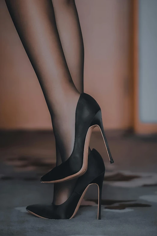 black high heels are shown, with one woman's legs bent behind the heels