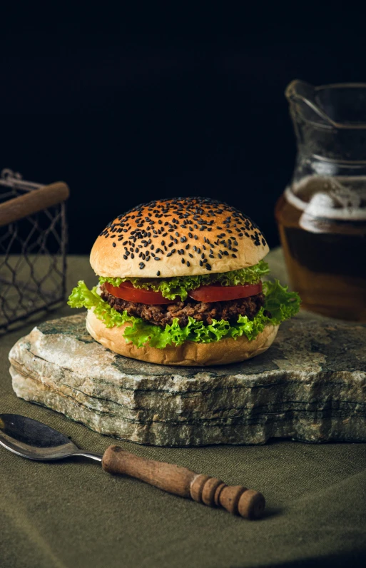 an image of a large hamburger with lettuce and tomatoes