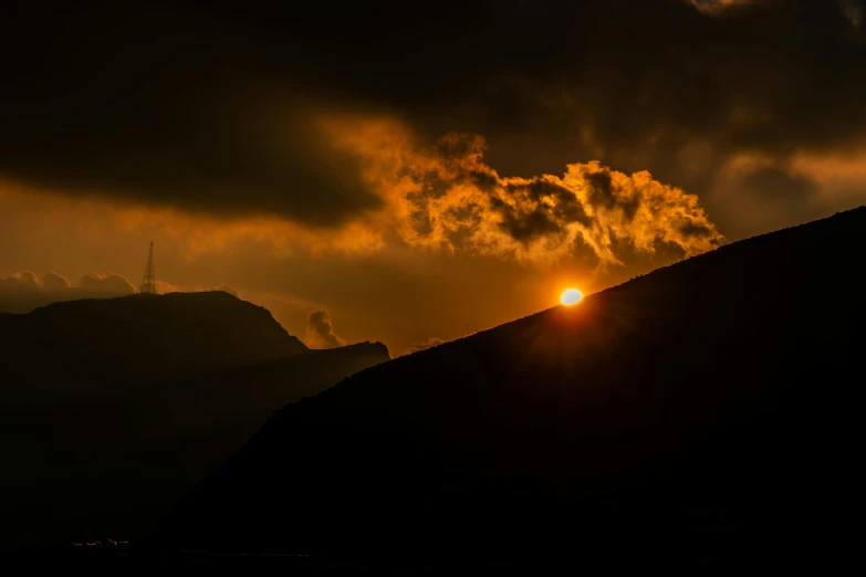 a very dark and gloomy picture with the sun in a dark sky