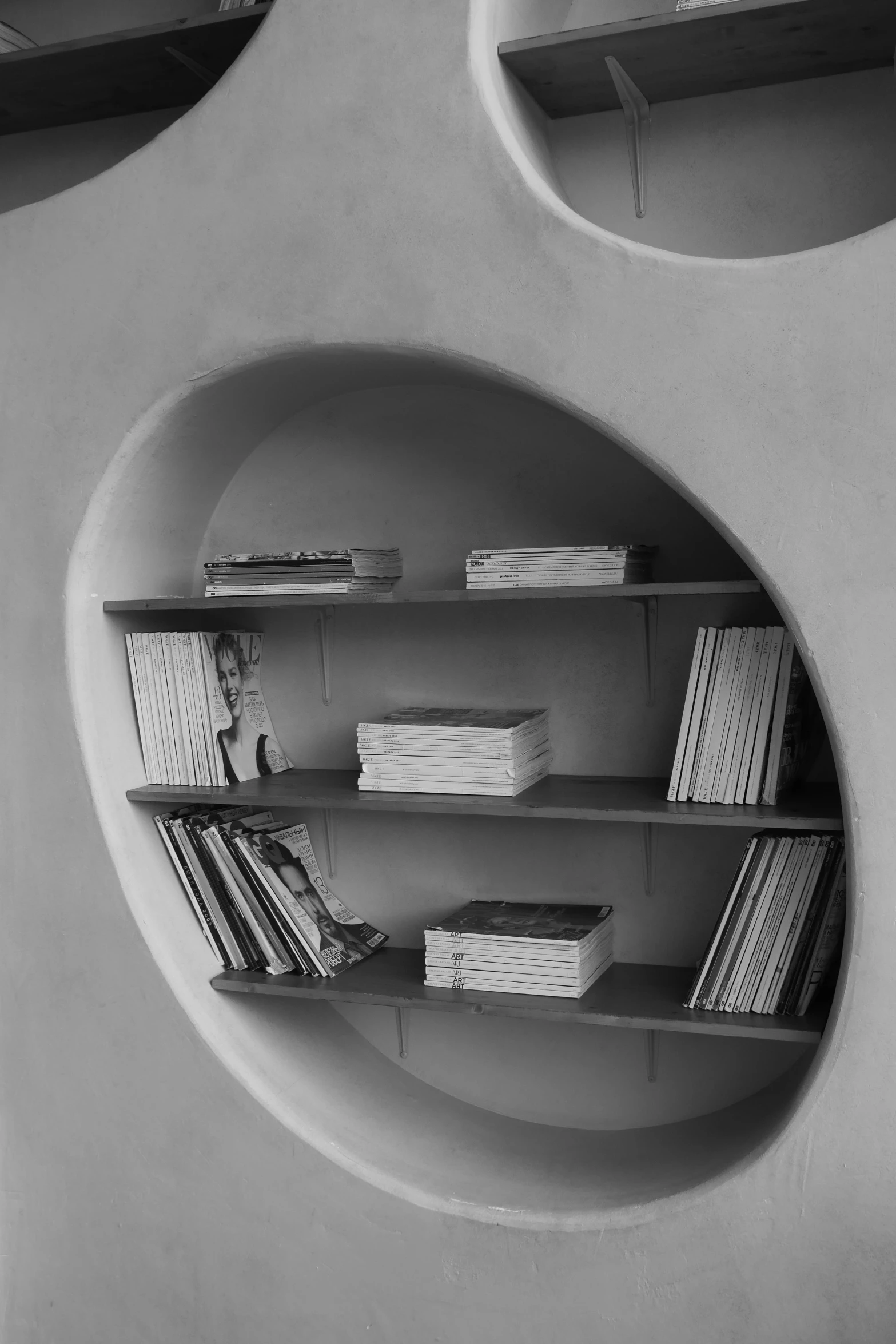 a round wall mounted shelf on the side of a wall