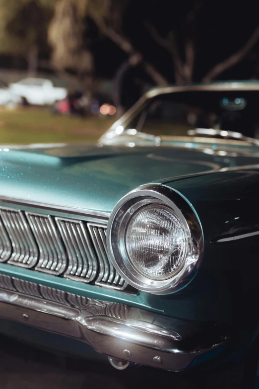 a close - up of the headlights and grilles of an older model car