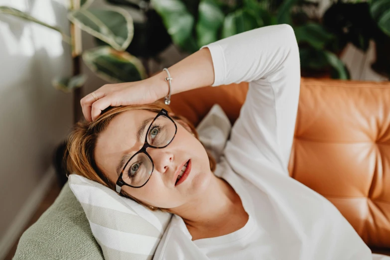 a woman that has glasses on laying down