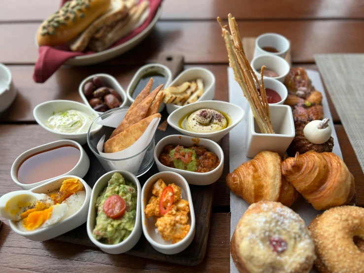 a table full of pastry and dessert dishes