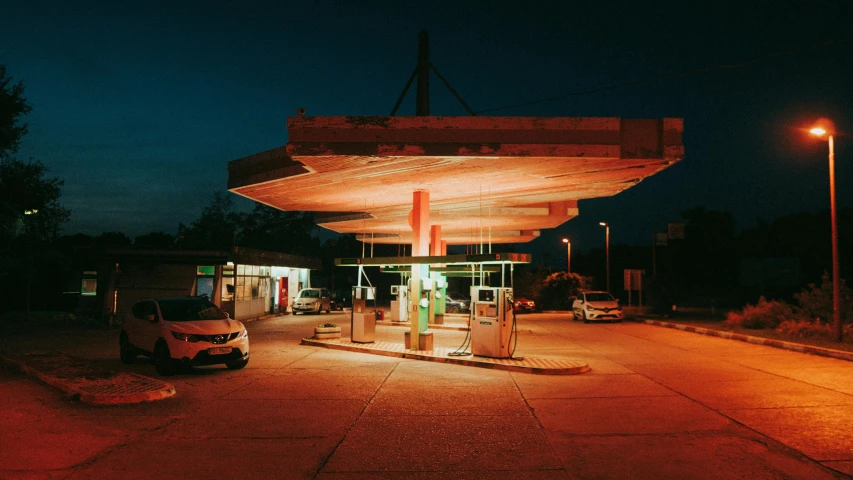 a gas station at night lit up with lights