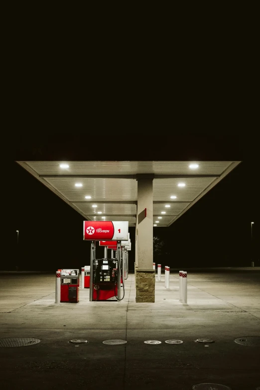 a gas station at night with a red light