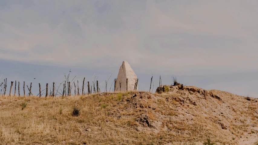 a long stone wall sitting in the middle of a desert