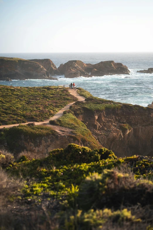 a scenic view of the ocean and shore with many rocks