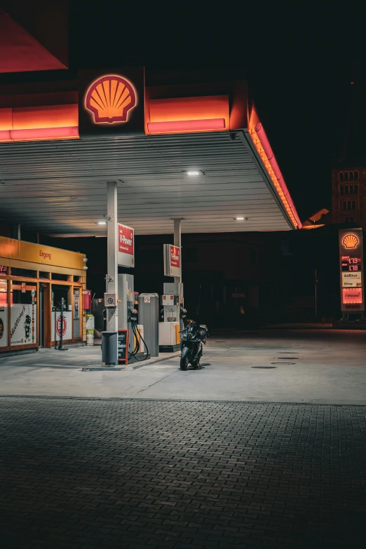 a fuel pump in front of a shell gas station