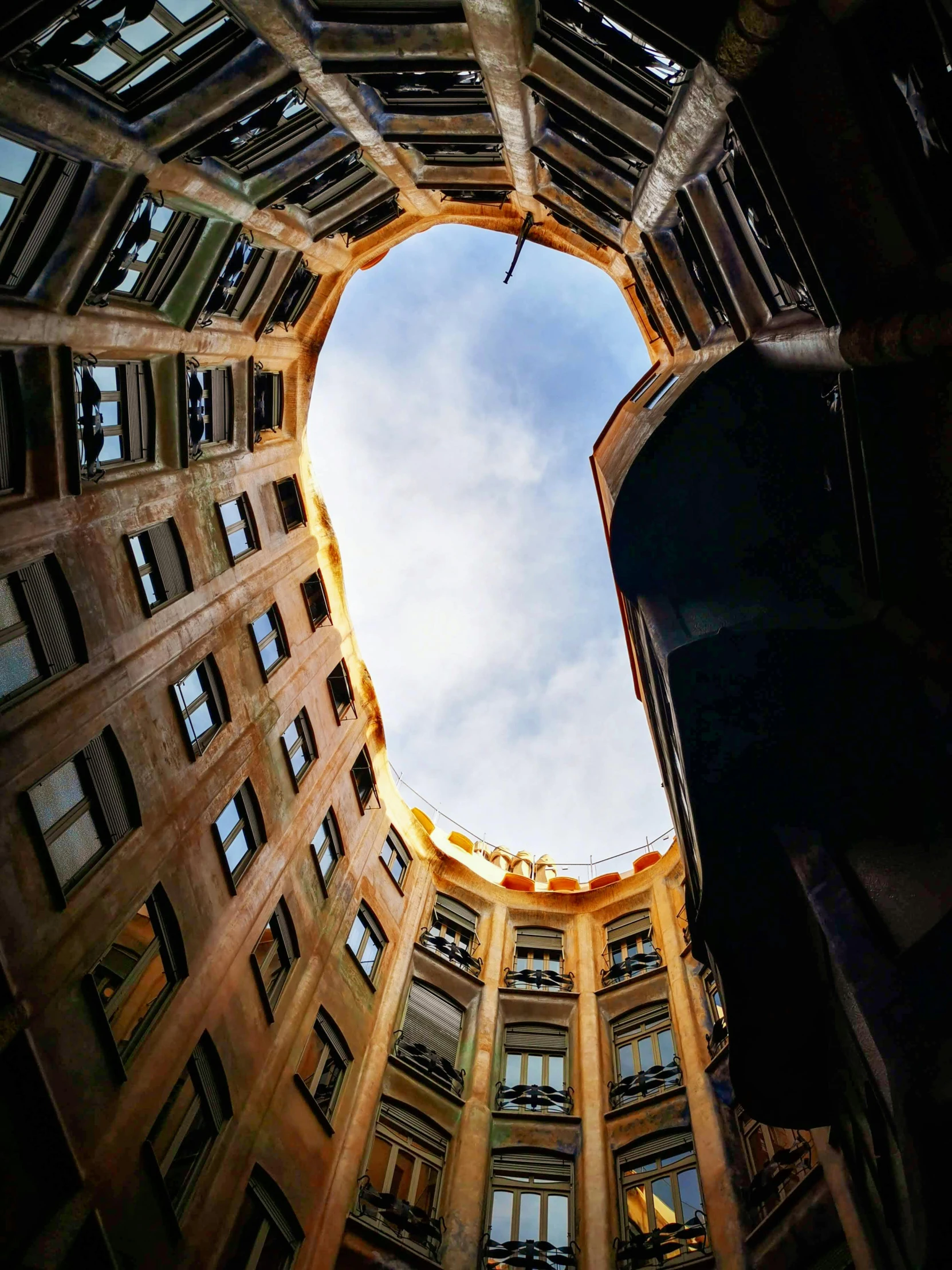 a high rise building looking up at the sky