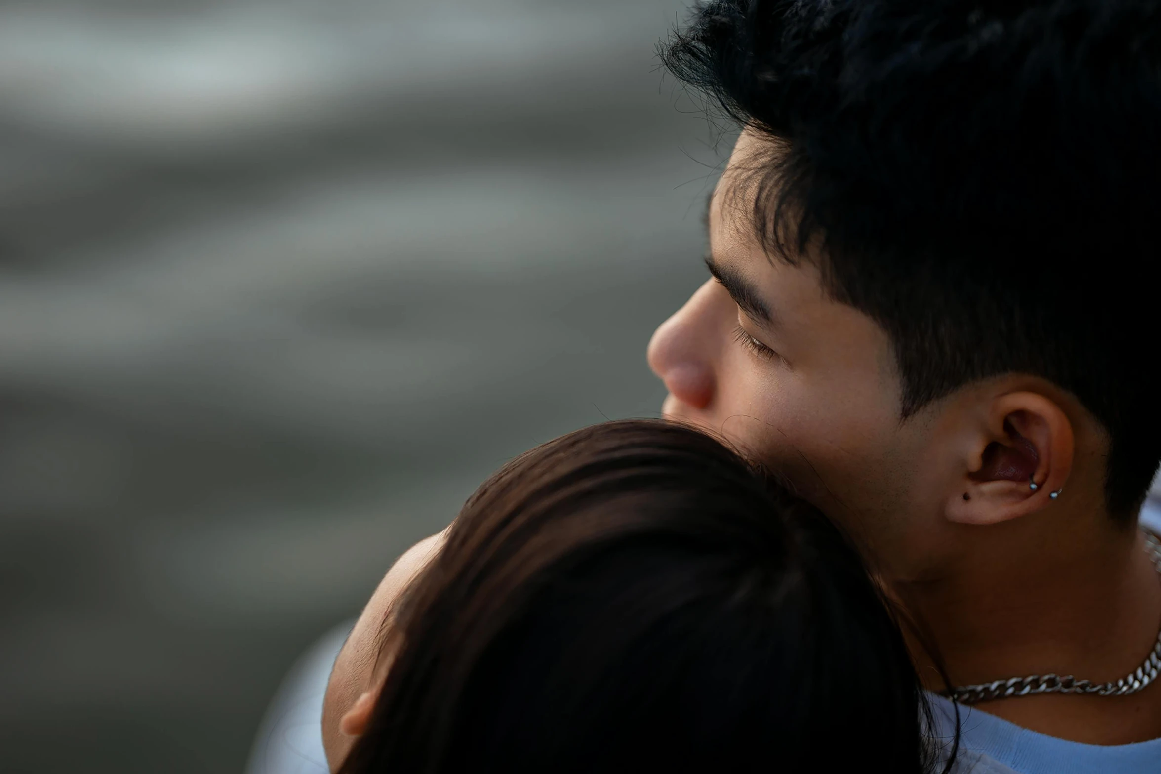 there is a young man and a girl that are standing close together