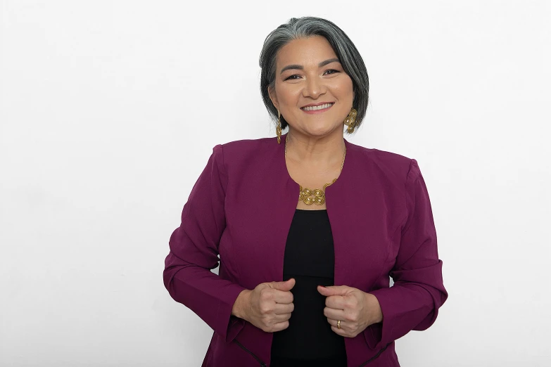 a woman wearing a pink jacket and a black shirt