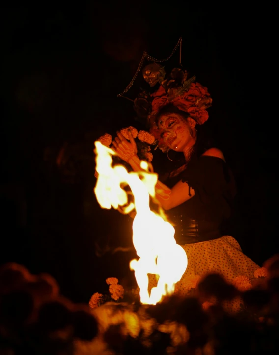 a woman on fire with a helmet and some flowers