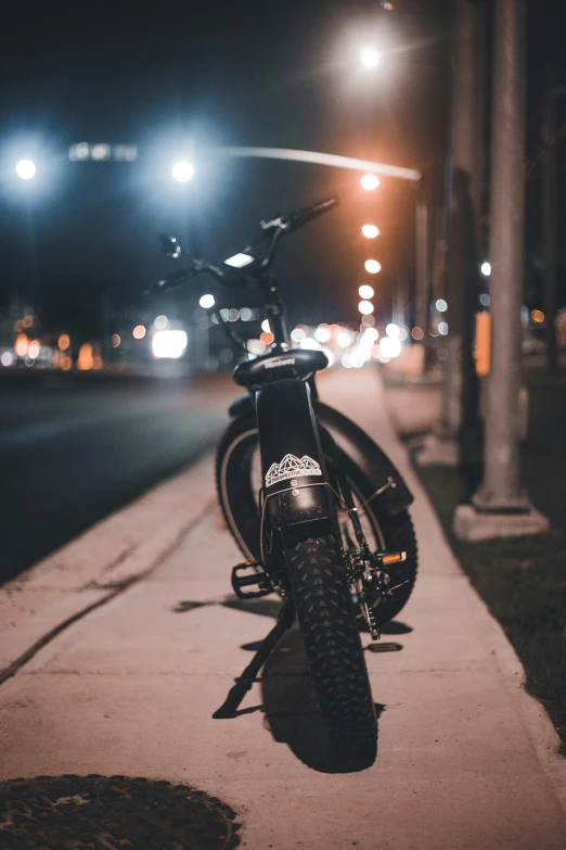 a bicycle is parked in a parking lot at night