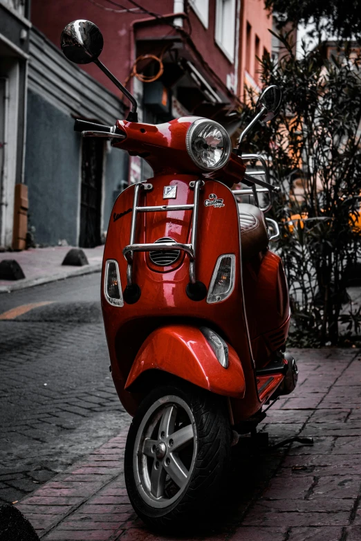 the back view of a red scooter on a city street