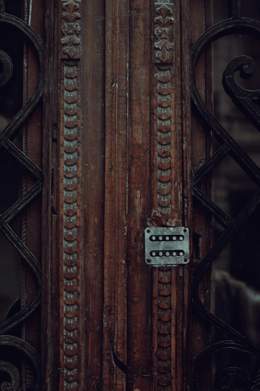 a metal latch sitting on the front door of a house