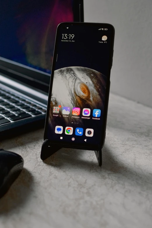 the iphone is connected to an ironing board next to a laptop