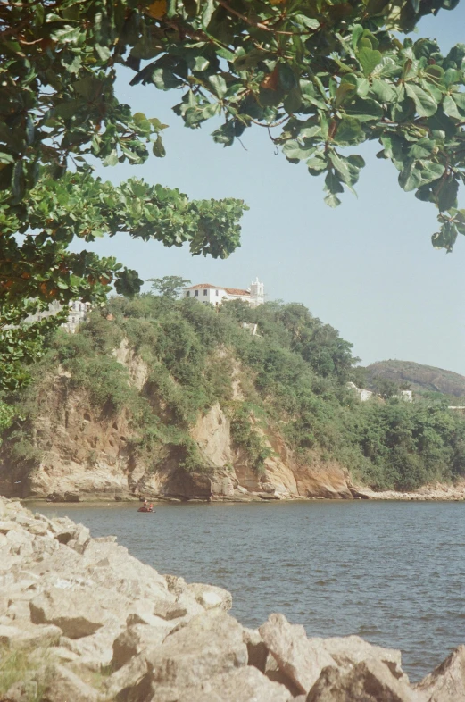 a beach with two people in boats floating down the water