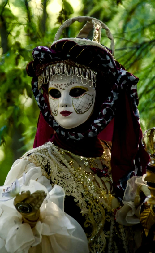 a woman wearing a black and white costume with a large veil on her head