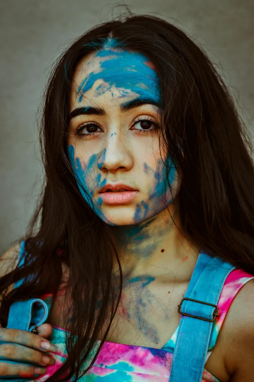 a girl with blue face and paint all over her body