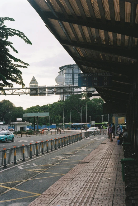 a group of people sit on benches near a walkway