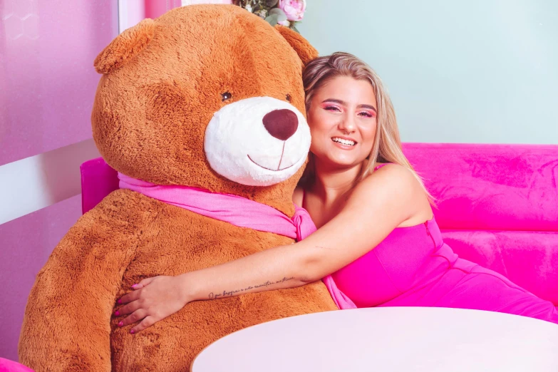 a woman posing with her huge teddy bear