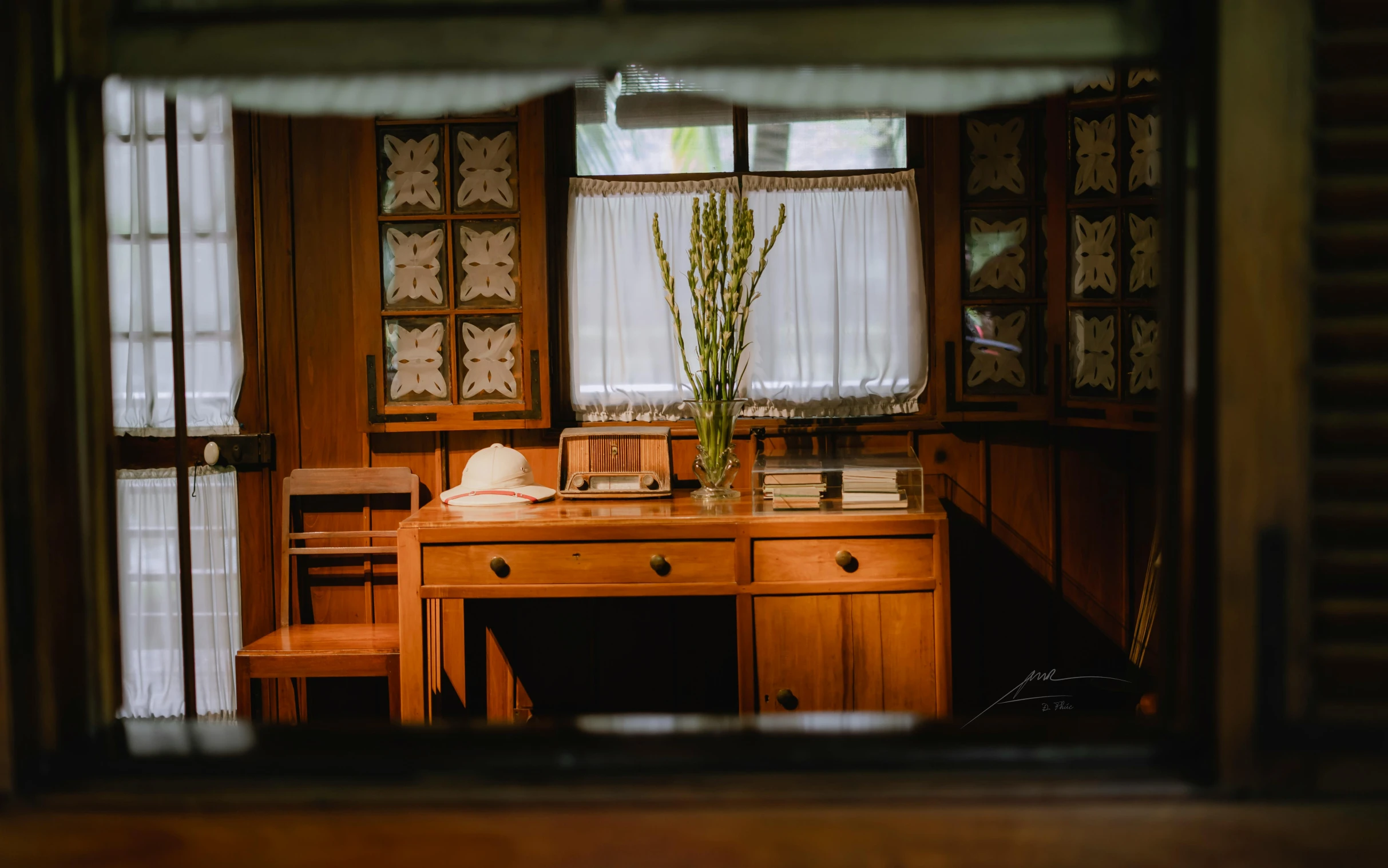 desk and chairs in room with open window