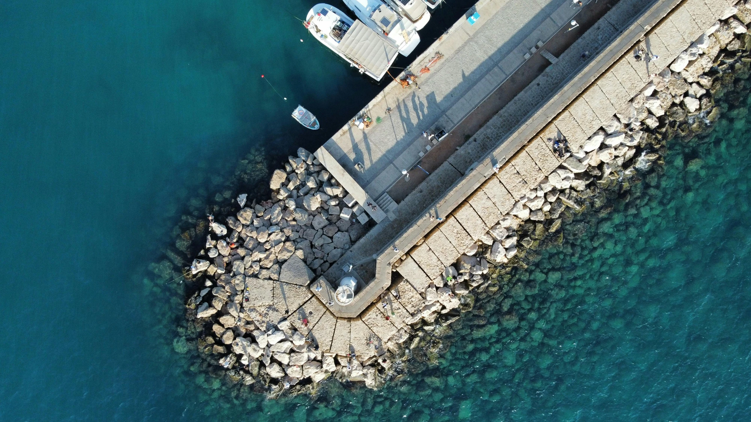 an aerial view of an outdoor pier in the middle of the sea