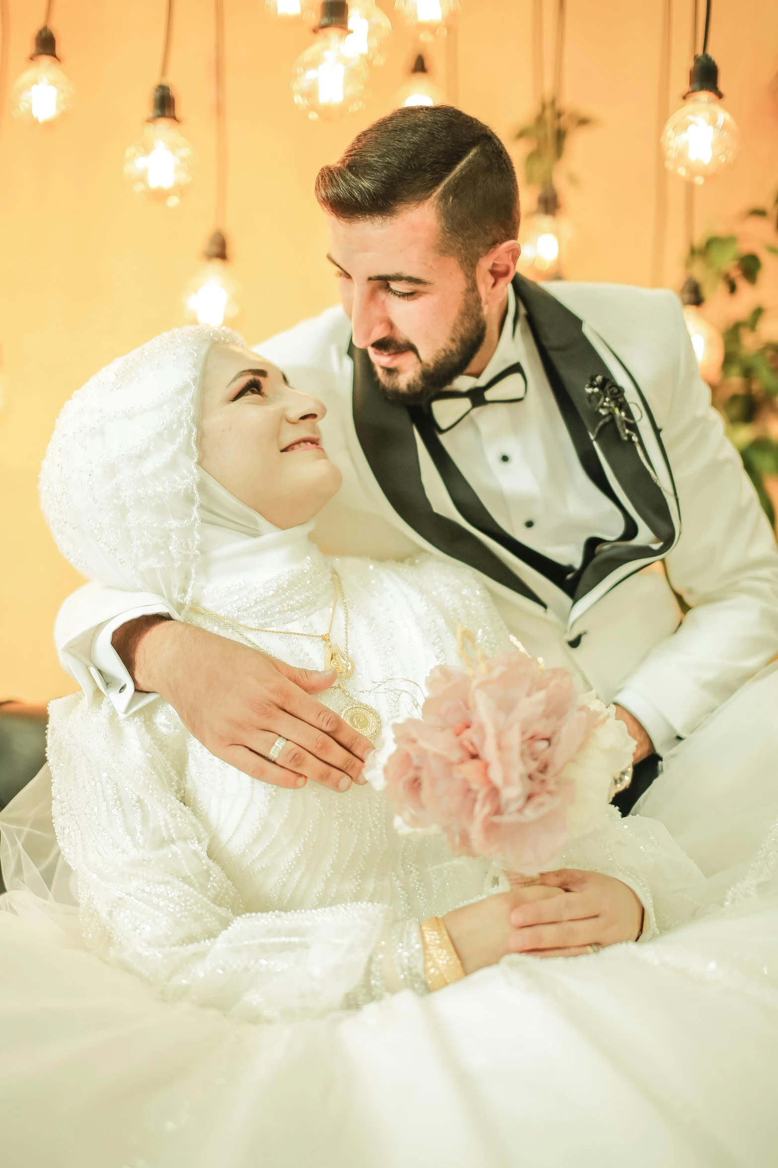 a man in a tuxedo hugging his bride