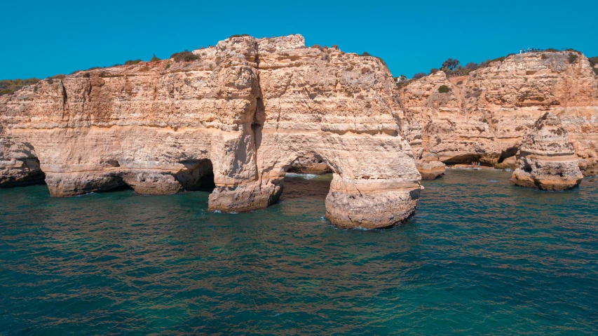 the rocky landscape features two towering towers near the beach