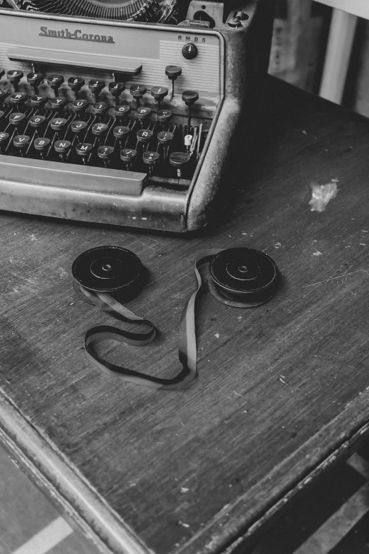 a very old typewriter sitting on a wooden table