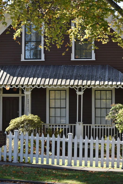 a big house with a long white picket fence