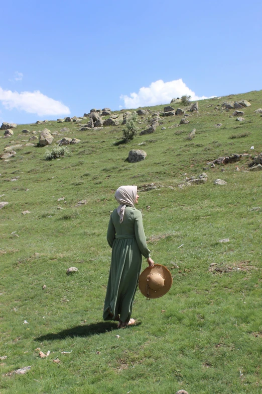 the woman is standing in a large open field