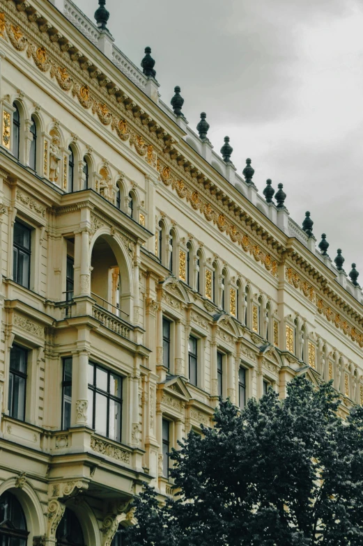 a very ornate building in front of some trees