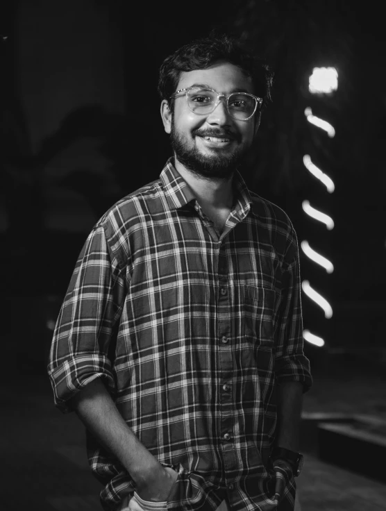 man in shirt with glasses posing for the camera