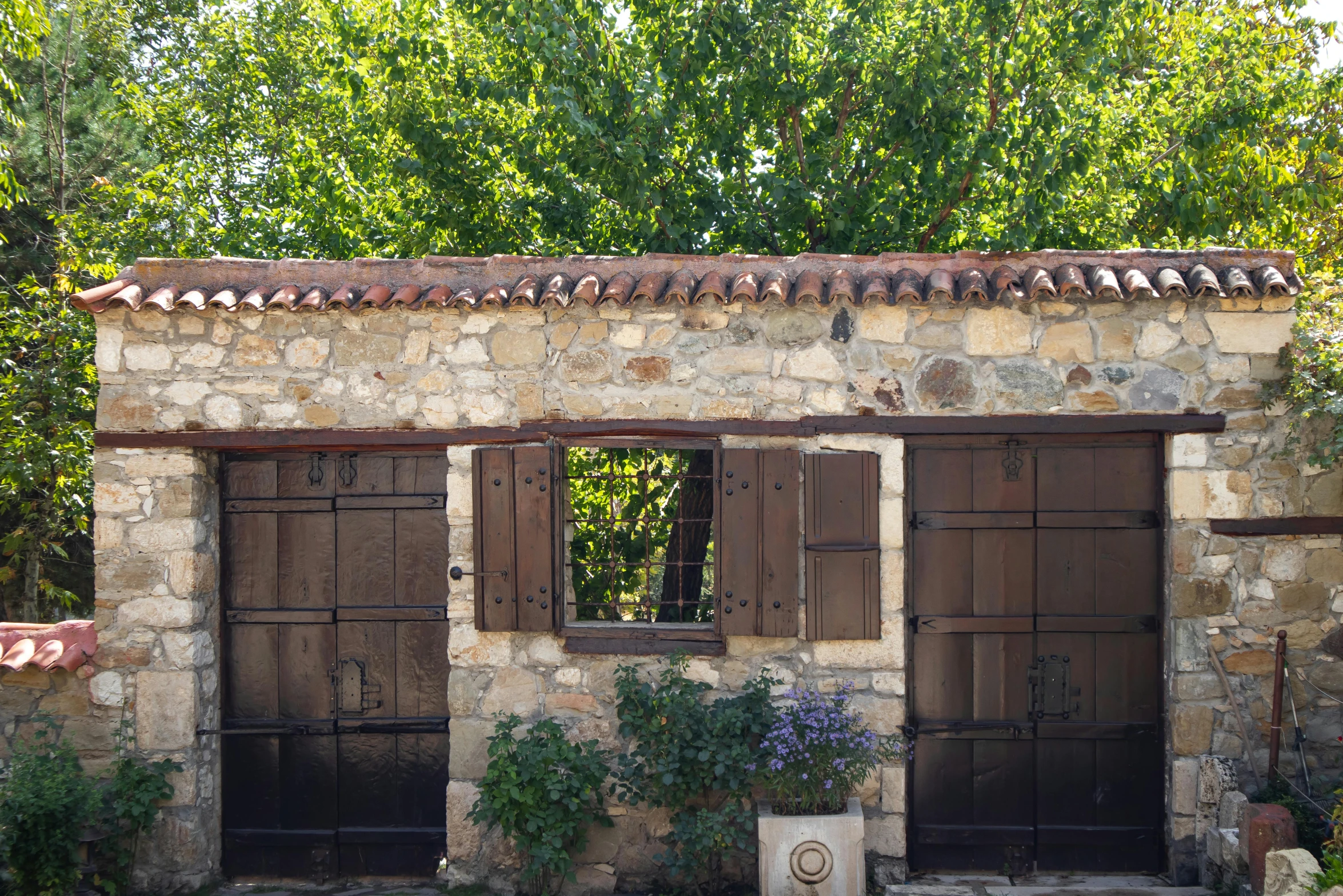 the old building has brown doors and windows on it