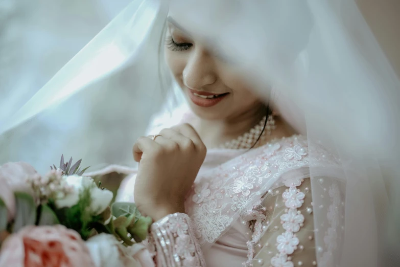 a bride is dressed in white and smiles