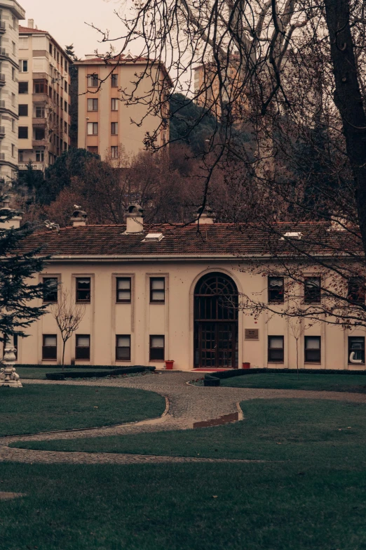 an old building is in the foreground and buildings on the other side