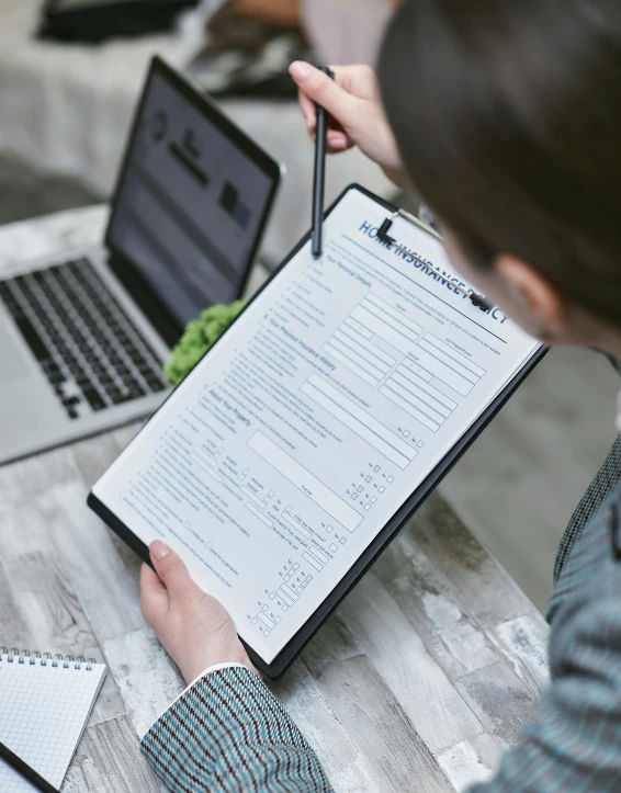 person at the table writing on a piece of paper