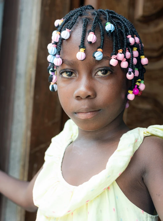 a girl with a colorful top on and a multi stranded hair