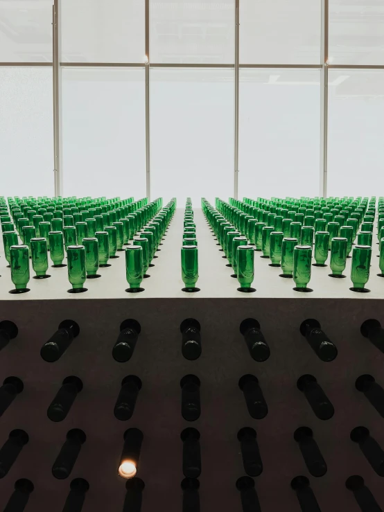 green bottles are arranged in a room of plastic