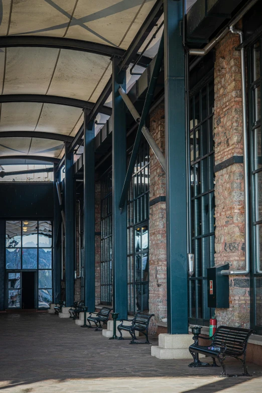 a empty building that has multiple benches under the roof