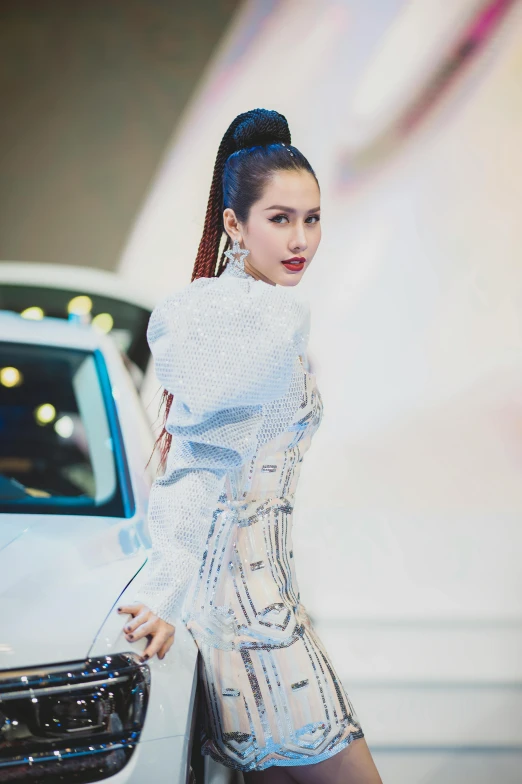 a woman is leaning against the side of a car